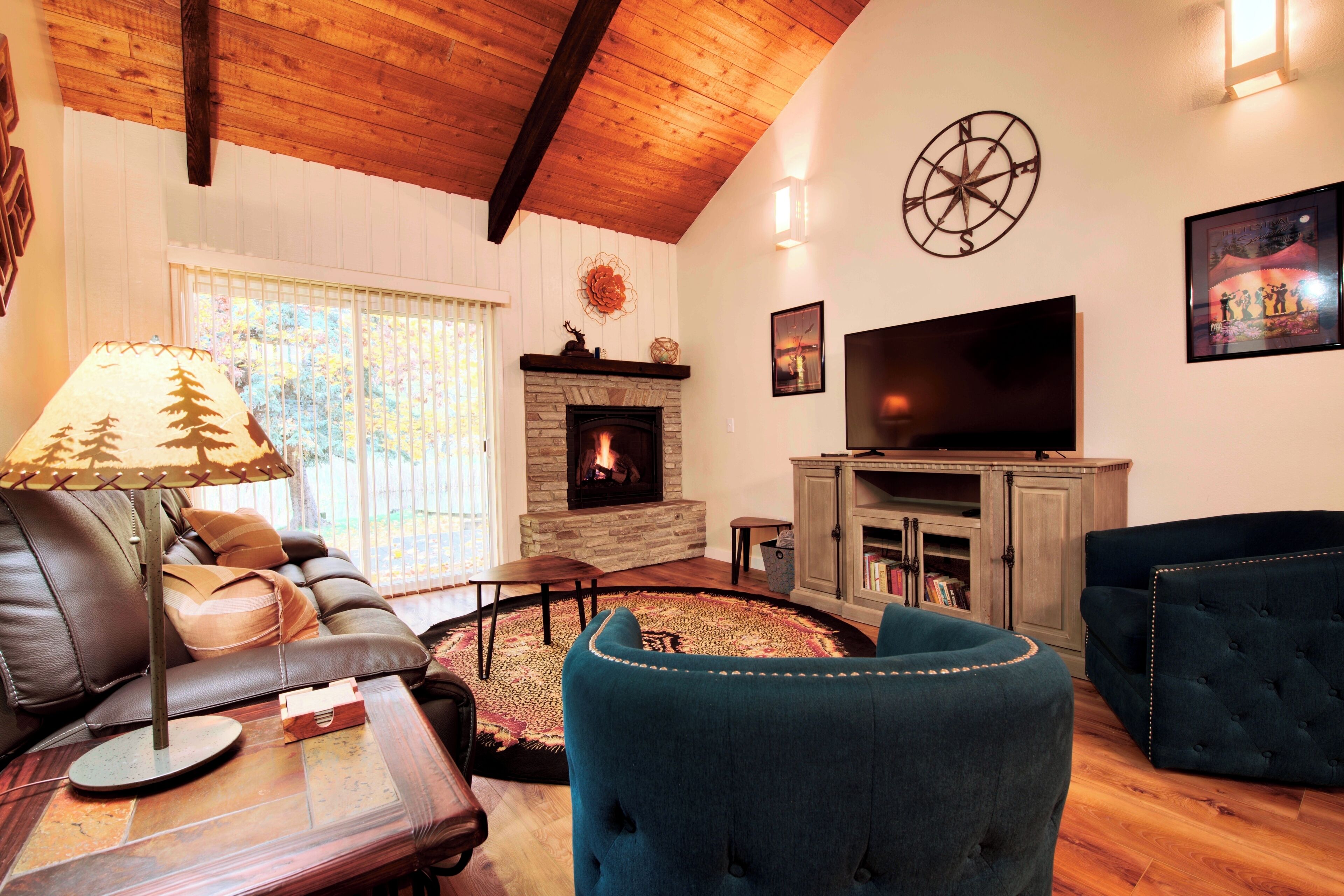 Living room with smart TV, gas fireplace leads to back patio.