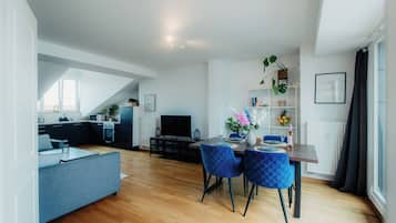 *Rooftop* 2-Zimmer-Apartment mit Wohnküche und Dachterrasse | Wohnbereich | 32-Zoll-Fernseher mit Kabelempfang