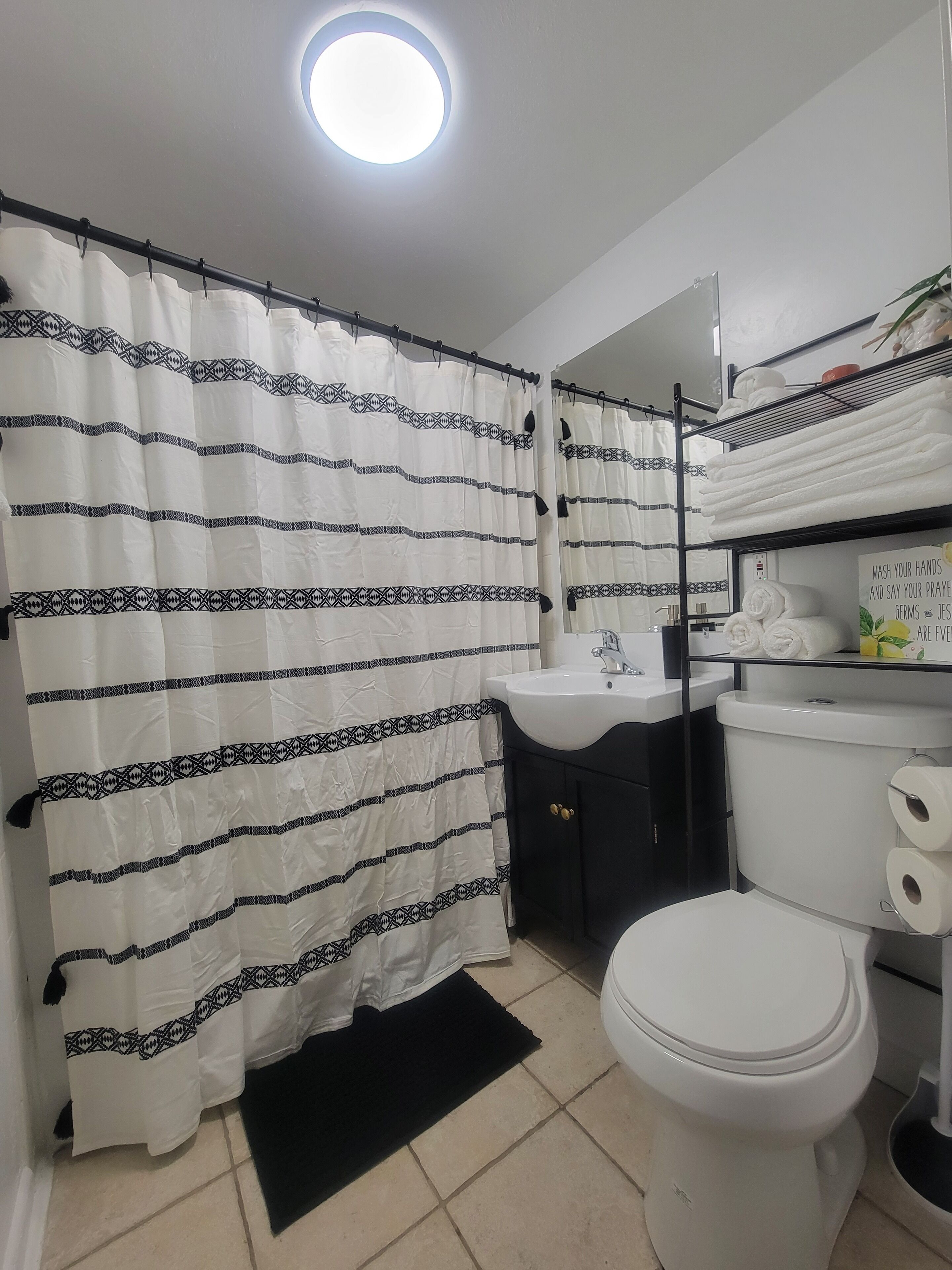 Combined shower/bathtub, hair dryer, towels, soap