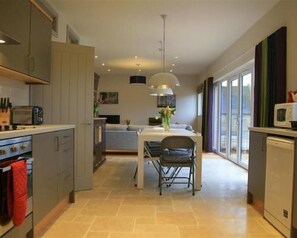 Enjoy meals in the kitchen with an oven and dining area featuring a table and chair.