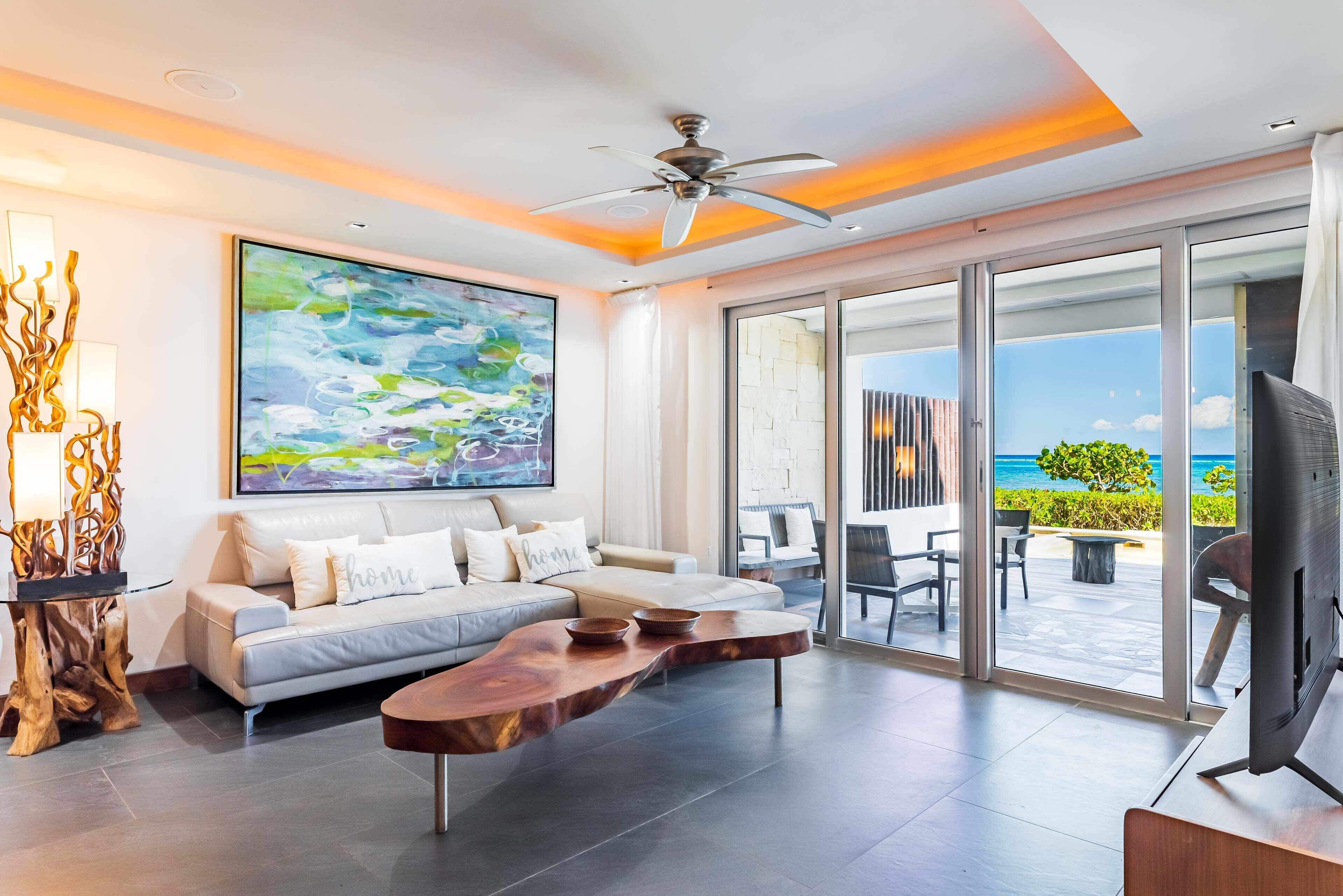 A modern living room with a sofa, coffee table, and artwork.