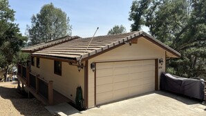 A single-story house with a garage, a covered patio, and a small porch. - Lake Naci Rendezvous with Lake Views (Bradley)