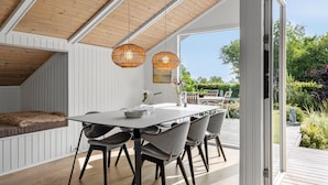 A modern dining area with a white table, grey chairs, and a wooden ceiling. - Lovely home in Odder with kitchen (Odder)