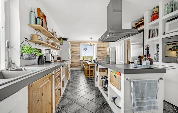 Fridge, stovetop, dishwasher, coffee/tea maker