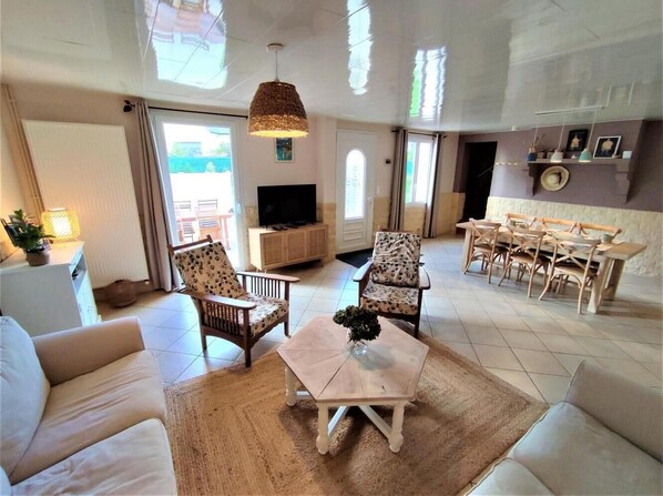 Relax in this inviting living area with a sofa, armchairs, and a coffee table, perfect for unwinding.