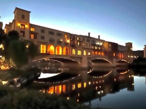 A historic building with arched windows and a reflective waterway. - Amazing Views & Pool - Lake Las Vegas Retreat (Henderson)