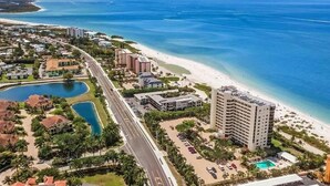 A coastal hotel with a beach view, a swimming pool, and a parking area. - Gulf Front Beach Life (Fort Myers Beach)