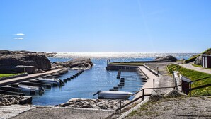 A coastal marina with boats docked, a clear sky, and a rocky shoreline. - Lovely home in Stavern with WiFi (Stavern)