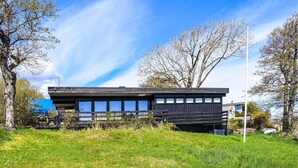 A modern building with a flat roof, large windows, and a minimalist design. - Lovely home in Stavern with WiFi (Stavern)