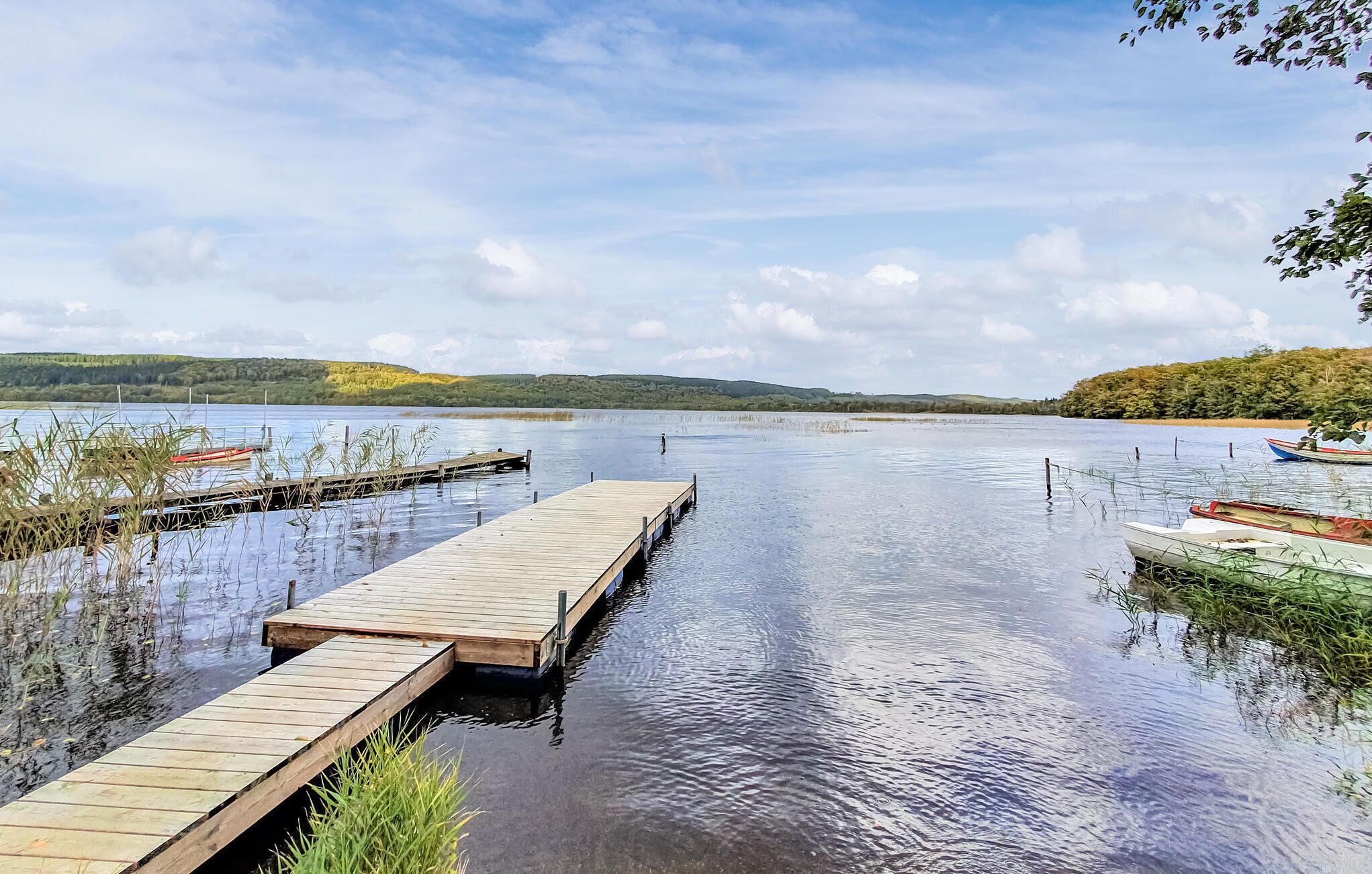 A calm lake with wooden docks extending into the water.