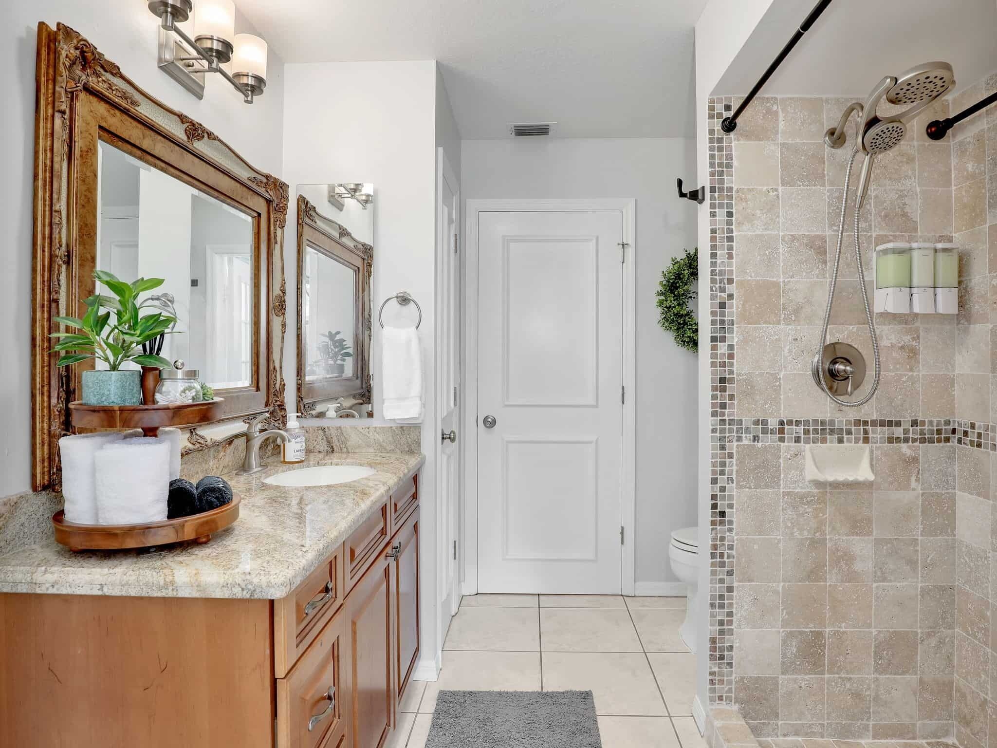 The 2nd bathroom has a spacious tile shower with adjustable shower head for a personalized experience.