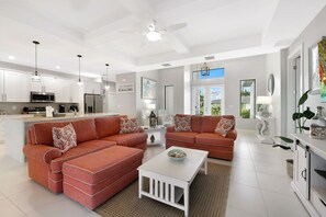 Relax in this spacious living area with a large L-shaped sofa, coffee table, and dining space.