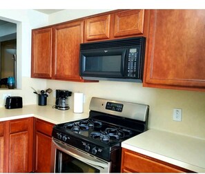Enjoy cooking in this well-equipped kitchen with a microwave, gas stove, and coffee maker.