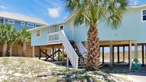 A beachfront house with a balcony, a staircase, and a palm tree. - Amethyst Dunes (Port St. Joe)