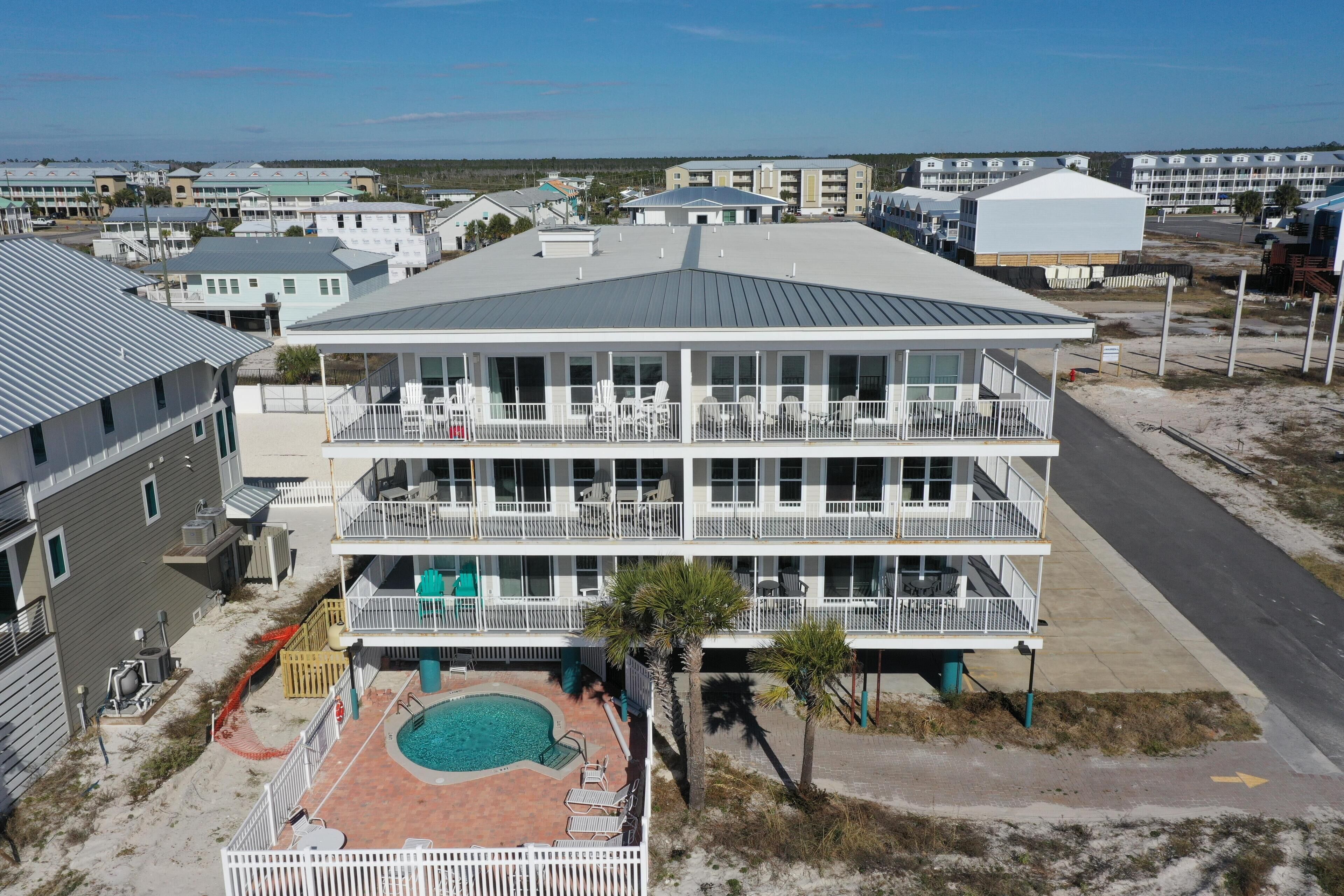 A multi-story hotel with a rooftop pool and outdoor seating.