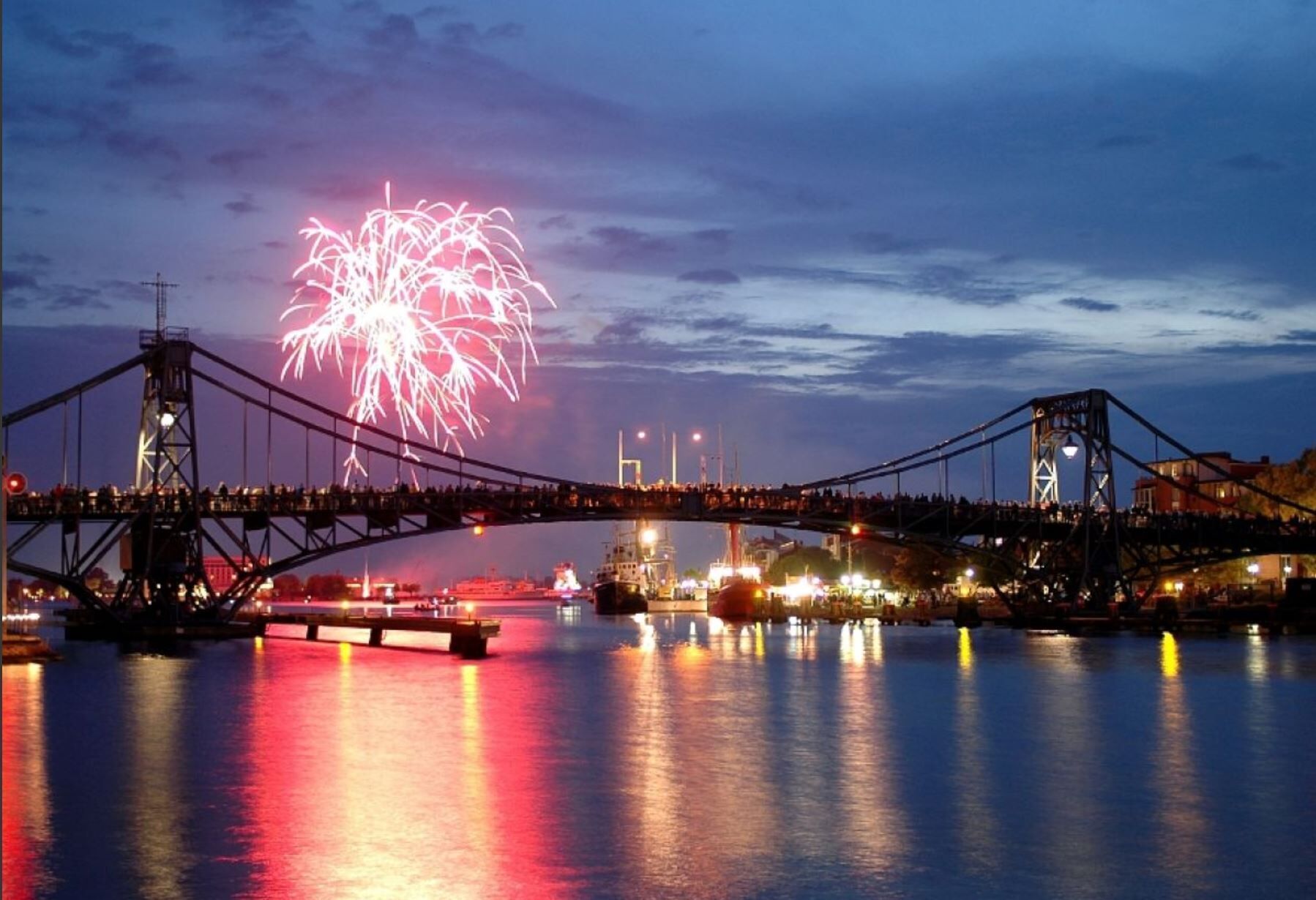 A bridge with fireworks in the background.
