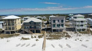 A coastal residential area with beachfront properties featuring balconies, a boardwalk, and sandy terrain. - A Turtle View (Port St. Joe)