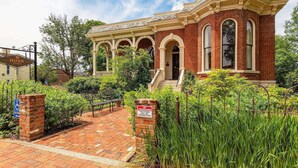 A historic building with a brick facade, arched windows, and a central entrance.