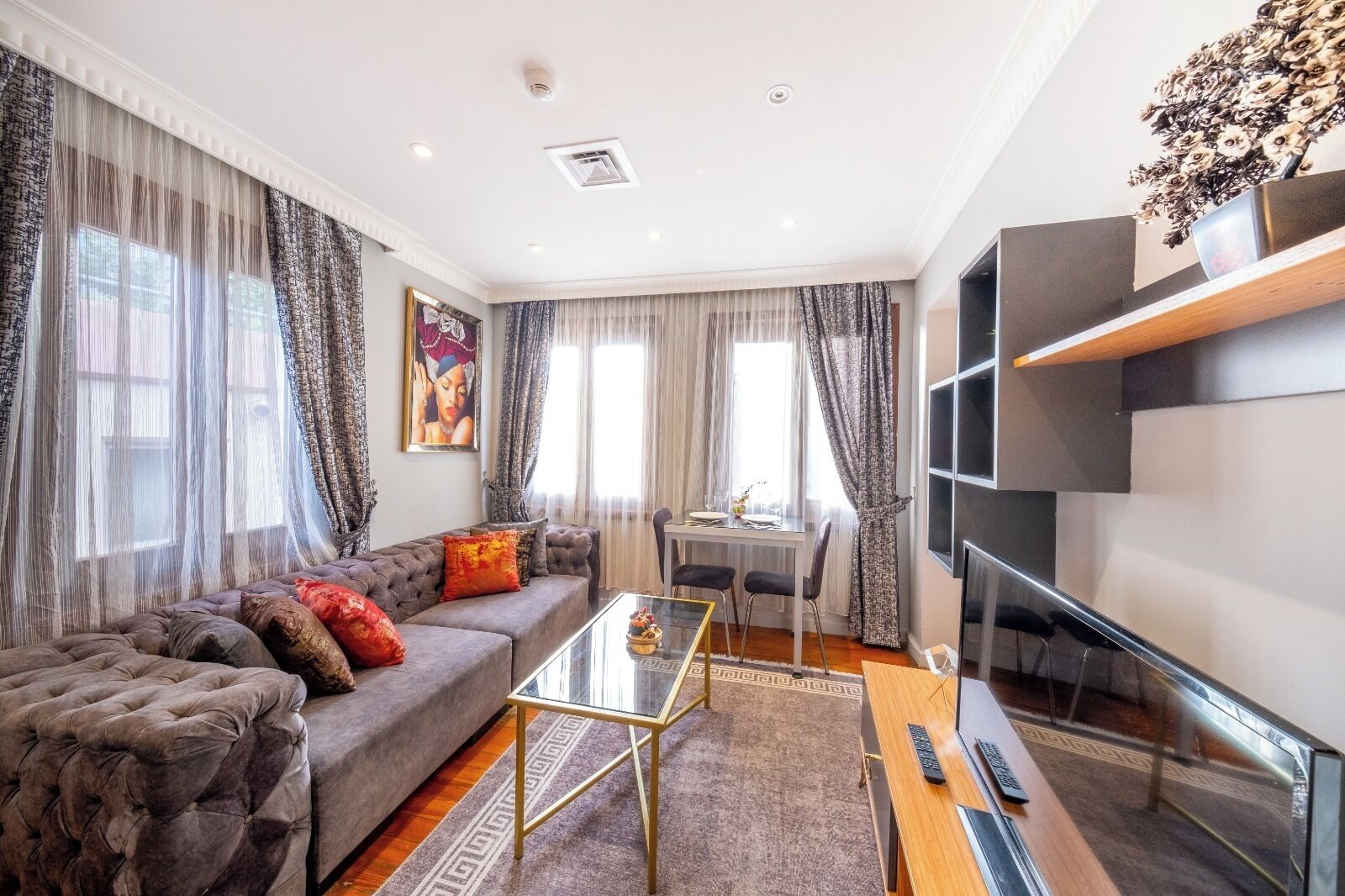 A modern living room with a sofa, coffee table, and TV.