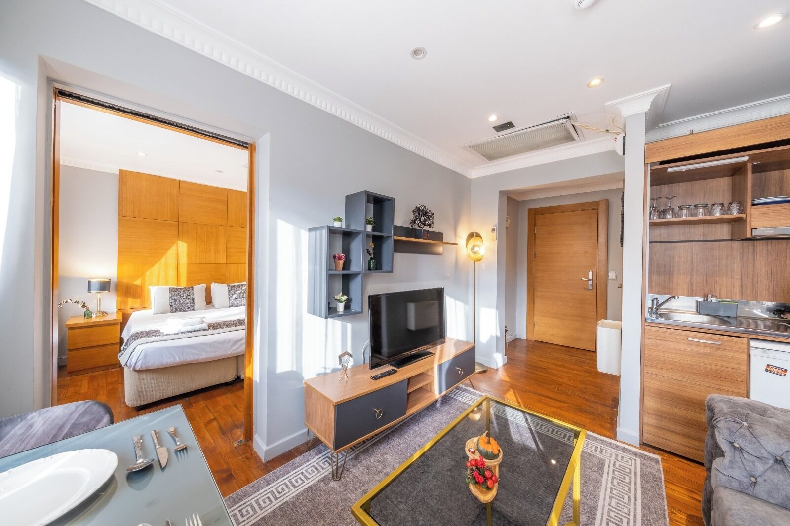 A modern apartment with a living room, bedroom, and kitchen.
