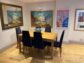 Enjoy meals in this stylish dining area with a wooden table and six chairs.