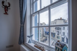 Enjoy the view of the town square from the large window, framed by a decorative welcome message.