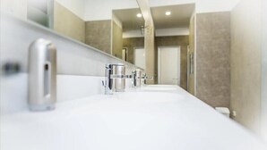 A modern bathroom with a long vanity, multiple sinks, and a large mirror. - Ai Hostel (Split)