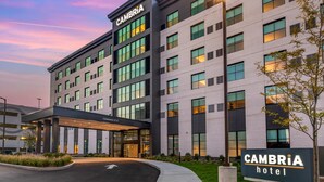 A modern hotel building with a sign reading "CAMBRIA hotel" and a covered entrance labeled "CAMBRIA 12th". - Cambria Hotel New Haven University Area (New Haven)