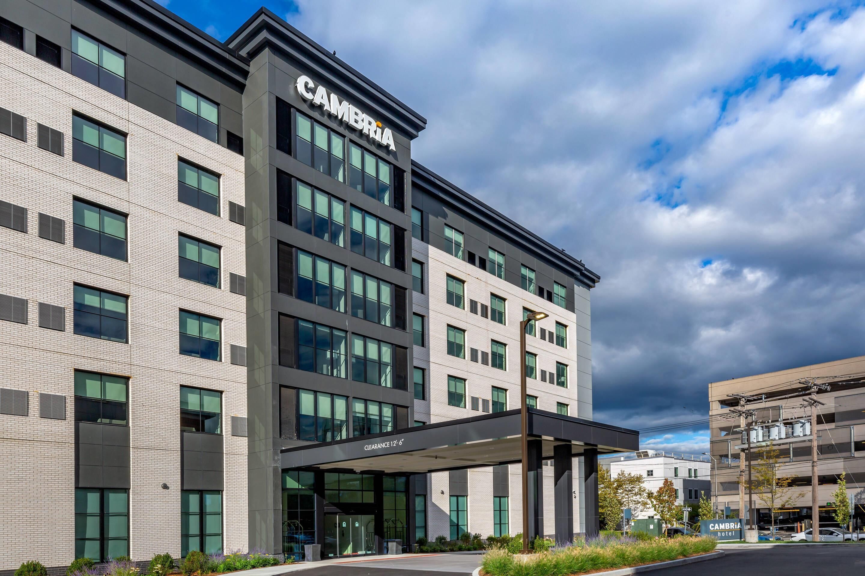 A modern building with a sign reading "CAMBRIA" and a covered entrance labeled "CLEARANCE 1-6".