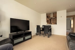Basic Apartment, Multiple Beds | Living room | TV