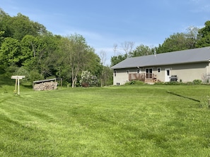 Huge back yard with grill and fire pit.