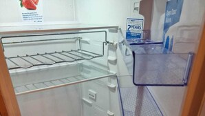 An empty refrigerator with multiple shelves and a freezer compartment. - Discover Comfort Home From Home 8-birth Caravan (Skegness)