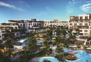 A resort with multiple buildings, a central swimming pool, and palm trees. - Nasma Luxury Stays - Madinat Jumeirah Living (Dubai)