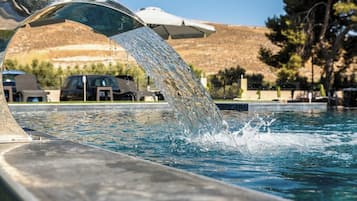 Seasonal outdoor pool, open 9:00 AM to 8:00 PM, pool umbrellas