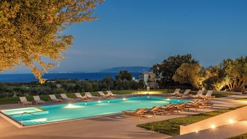 Seasonal outdoor pool, open 9:00 AM to 9:00 PM, pool umbrellas