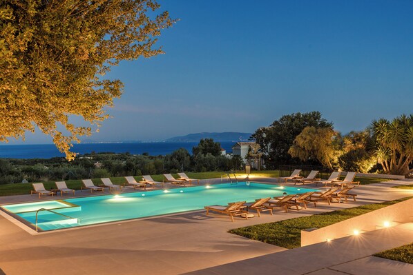 Seasonal outdoor pool, open 9:00 AM to 9:00 PM, pool umbrellas