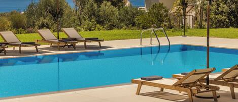 Seasonal outdoor pool, open 9:00 AM to 9:00 PM, pool umbrellas
