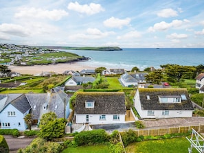 A coastal village with houses, a beach, and the sea.