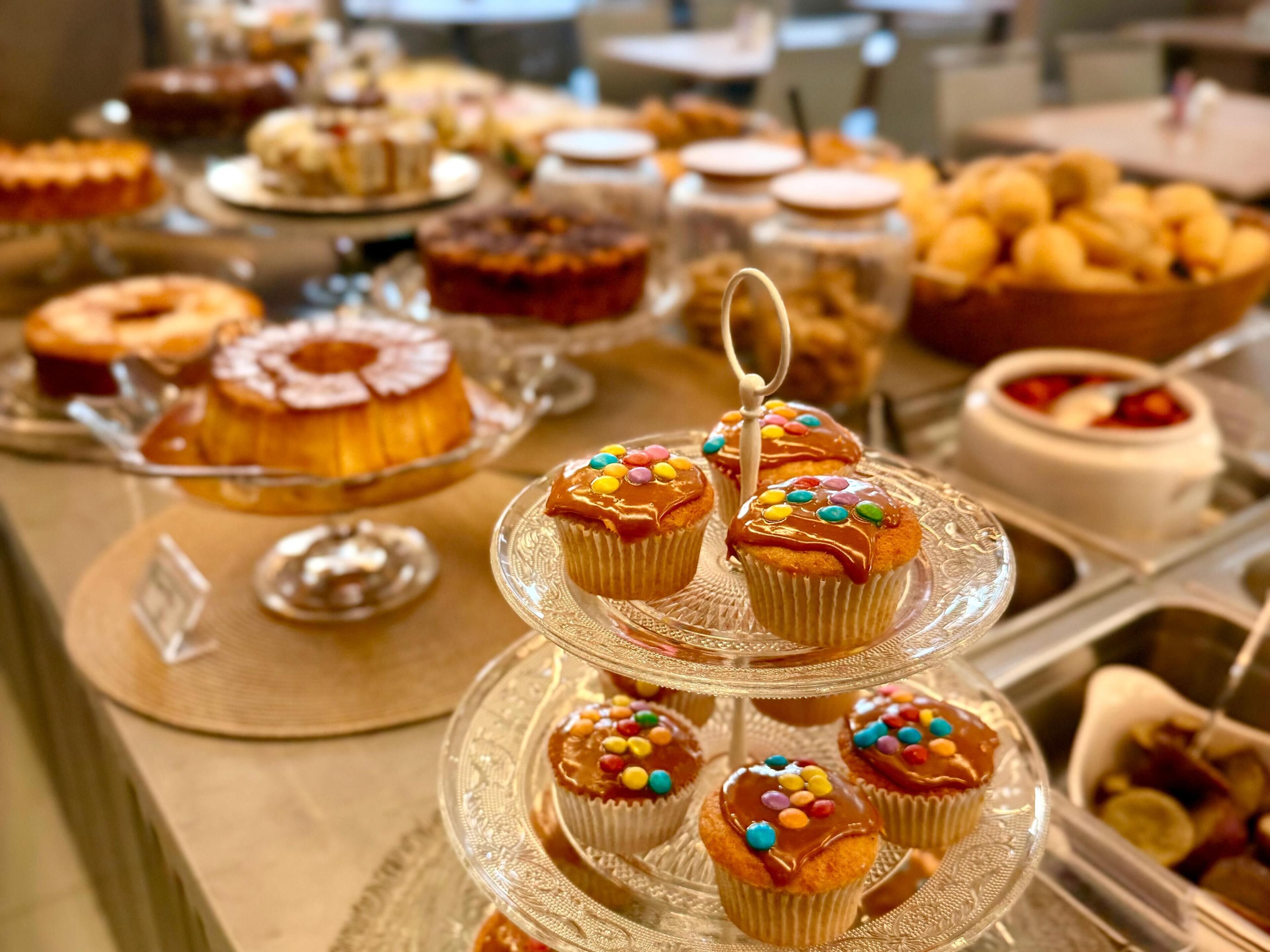 A buffet with various desserts including cupcakes and cakes.