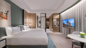 A modern hotel room with a large bed, a desk, and a television. - Novotel Shanghai Wanyuan (Shanghai)