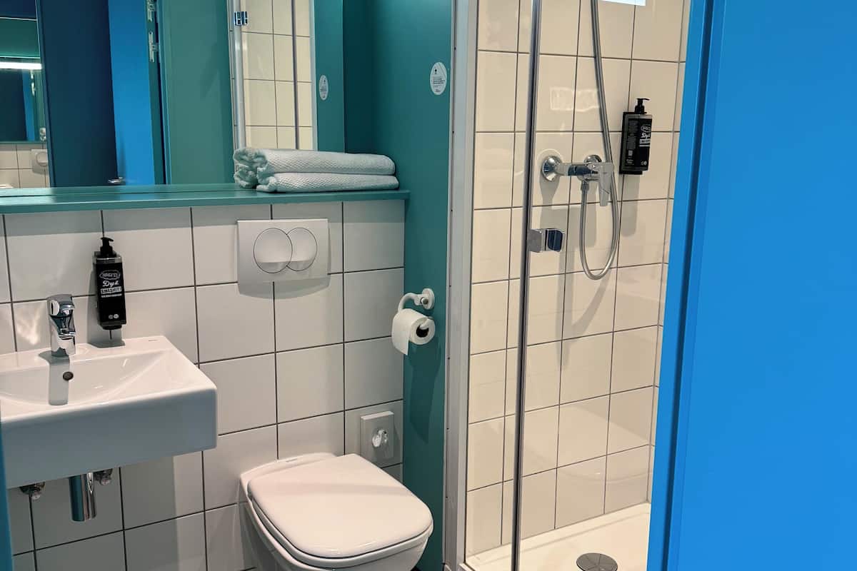 standard room, 2 single beds | bathroom | shower, eco-friendly toiletries, hair dryer, towels