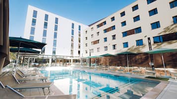 Seasonal outdoor pool, open 10:00 AM to 10:00 PM, pool umbrellas