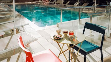 Seasonal outdoor pool, open 10:00 AM to 10:00 PM, pool umbrellas