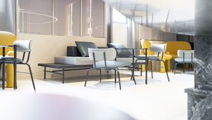 A modern interior with a seating area featuring sofas and chairs, a large window with a view, and a minimalist design. - Palazzo Tirso Cagliari Mgallery (Cagliari)