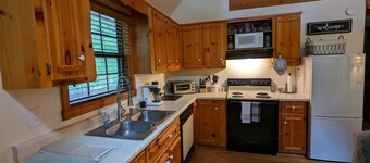 Cozy cabin with wrap around porch and only minutes to town!