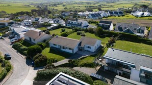 A residential area with houses featuring pitched roofs and solar panels.