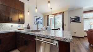 A modern kitchen with granite countertops, stainless steel appliances, and wooden cabinets. - Solstice #14 2 Bedroom Condo by RedAwning (Mammoth Lakes)