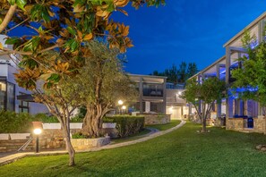 Stunning two-story residence with a well-manicured lawn and lush trees.