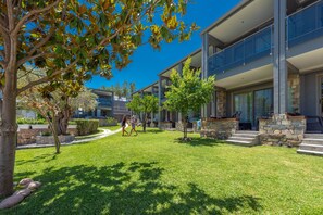 Enjoy the serene atmosphere of our outdoor space, featuring a well-maintained lawn and beautiful trees.