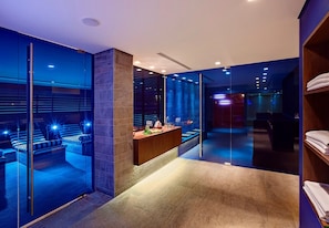 Relax in a contemporary space with a lounge area, featuring a bench and table for refreshments.
